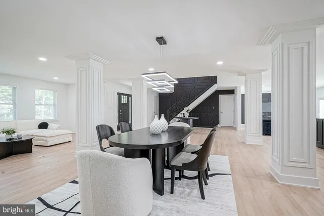 a dining room with furniture and wooden floor