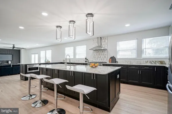 a kitchen with granite countertop a sink and cabinets