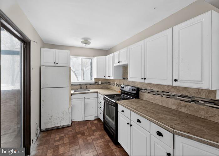 1538 Deer Run East Bushkill, PA 18324 - Photo 11 of 18 a kitchen with granite countertop white cabinets white stainless steel appliances and a sink