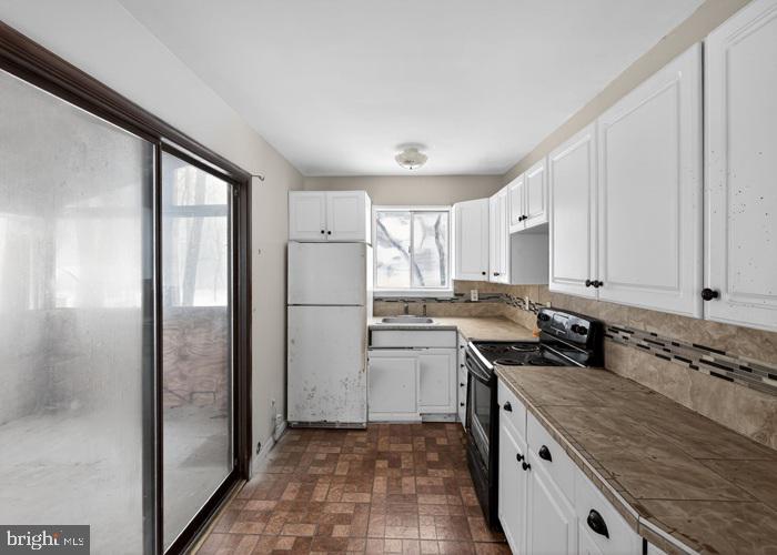 1538 Deer Run East Bushkill, PA 18324 - Photo 12 of 18 a kitchen with stainless steel appliances granite countertop a refrigerator a sink and white cabinets