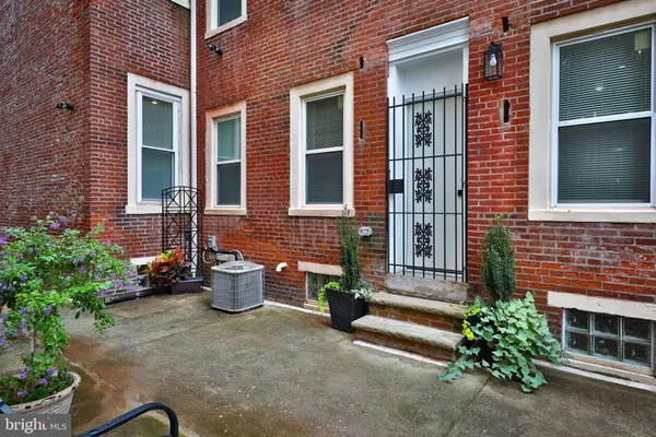a view of a brick house with many windows