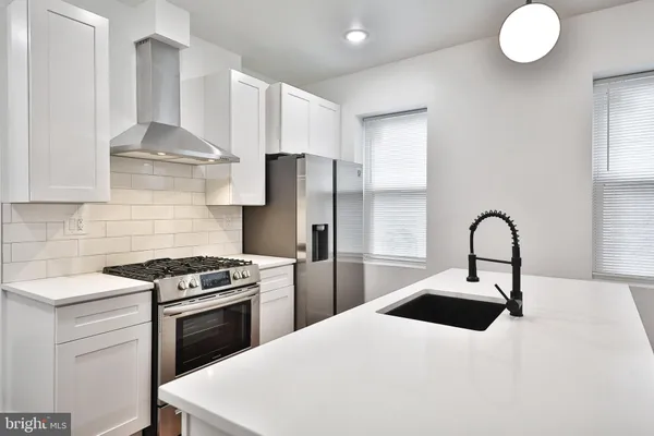 a kitchen with a sink a stove and refrigerator
