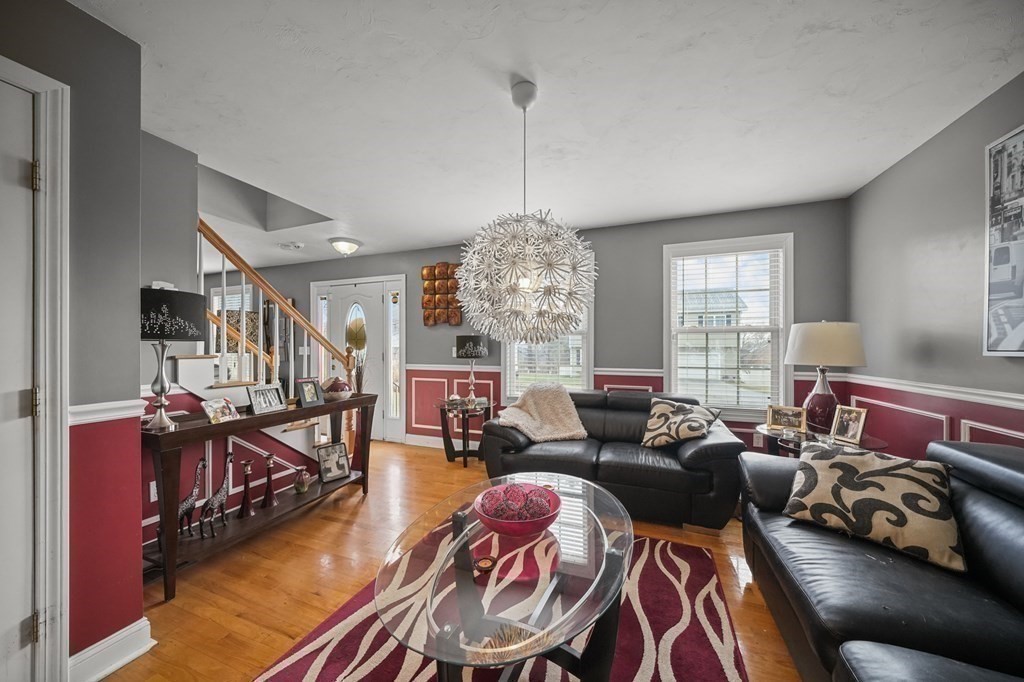 3 Carter Way Worcester, MA 01609 - Photo 15 of 32 a living room with furniture and a chandelier