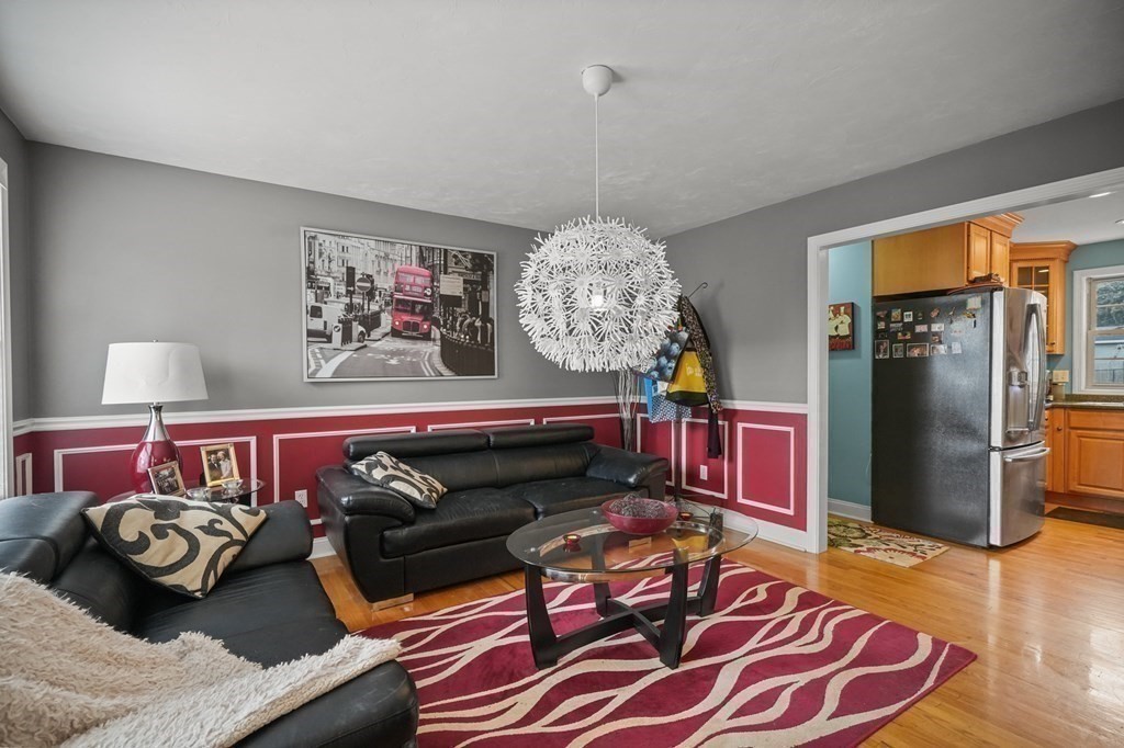 3 Carter Way Worcester, MA 01609 - Photo 16 of 32 a living room with furniture a chandelier and a rug