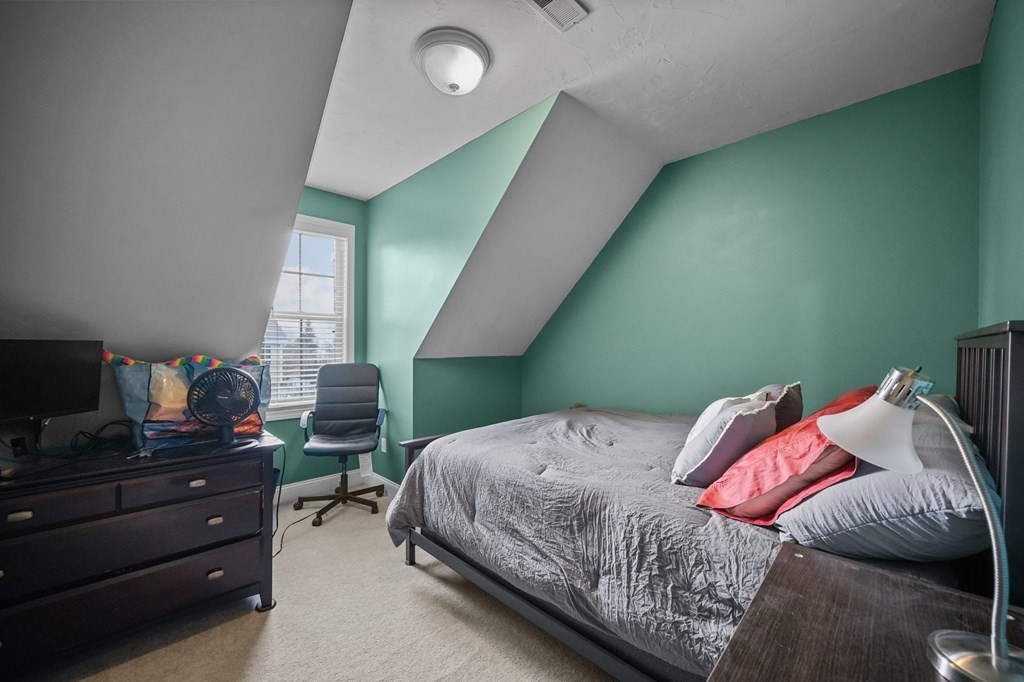 3 Carter Way Worcester, MA 01609 - Photo 21 of 32 a bedroom with a bed and a flat tv screen on dresser