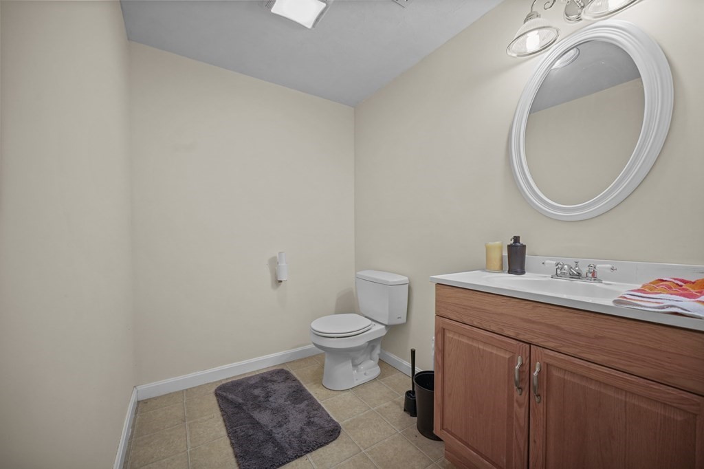3 Carter Way Worcester, MA 01609 - Photo 24 of 32 a bathroom with a toilet a sink and a mirror