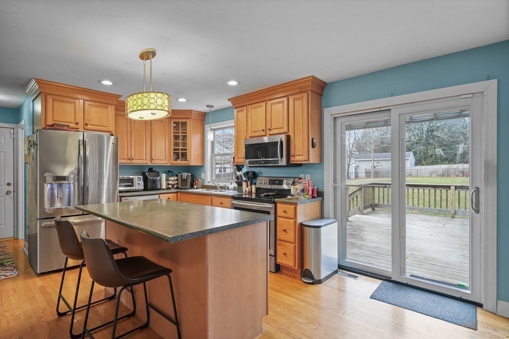 3 Carter Way Worcester, MA 01609 - Photo 10 of 32 a kitchen with stainless steel appliances granite countertop a refrigerator a stove top oven a sink dishwasher and wooden cabinets
