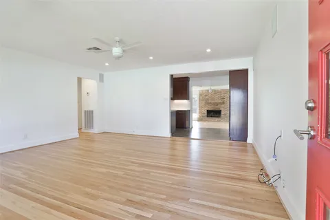a view of empty room with wooden floor