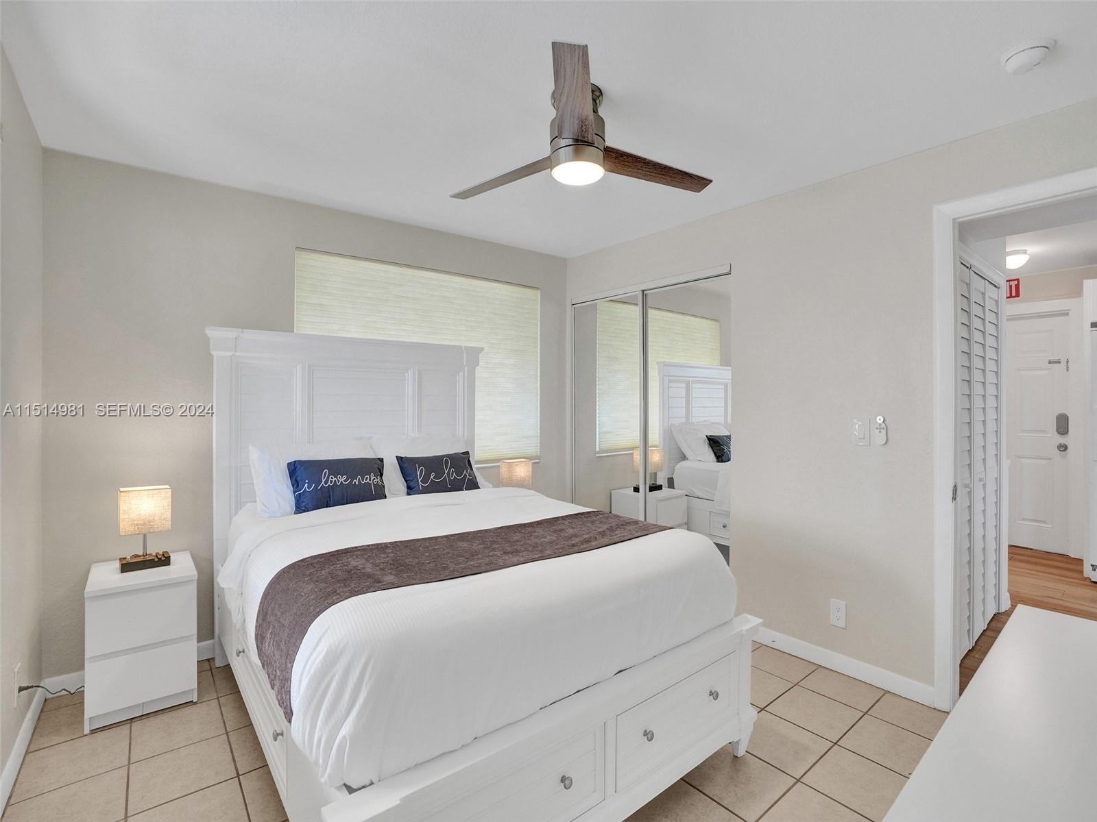 900 North Surf Road, Unit 2 Hollywood, FL 33019 - Photo 12 of 48 a bedroom with a bed and a lamp