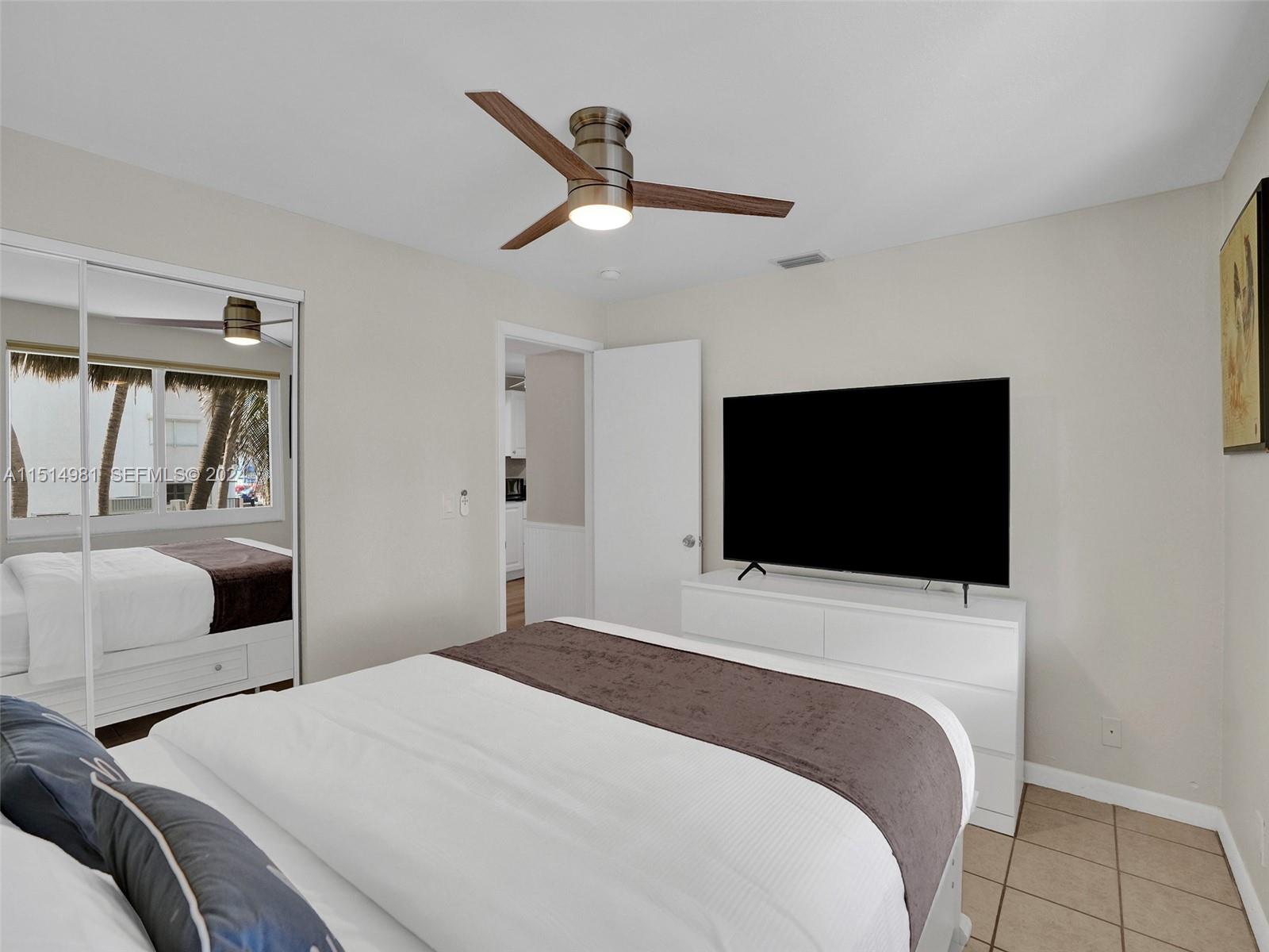 900 North Surf Road, Unit 2 Hollywood, FL 33019 - Photo 13 of 48 a bedroom with a bed and a flat screen tv