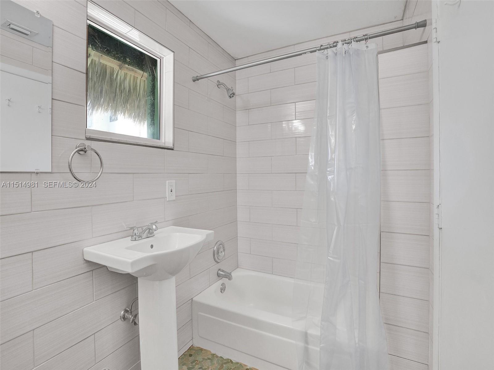 900 North Surf Road, Unit 2 Hollywood, FL 33019 - Photo 17 of 48 a bathroom with a sink and mirror