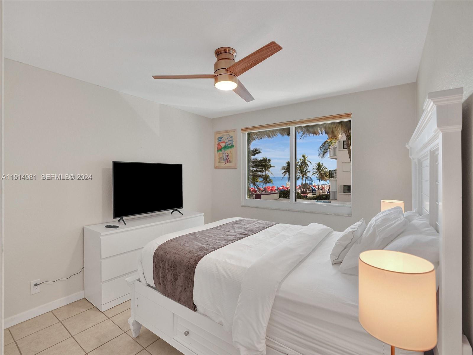 900 North Surf Road, Unit 2 Hollywood, FL 33019 - Photo 18 of 48 a bedroom with a bed and a large window