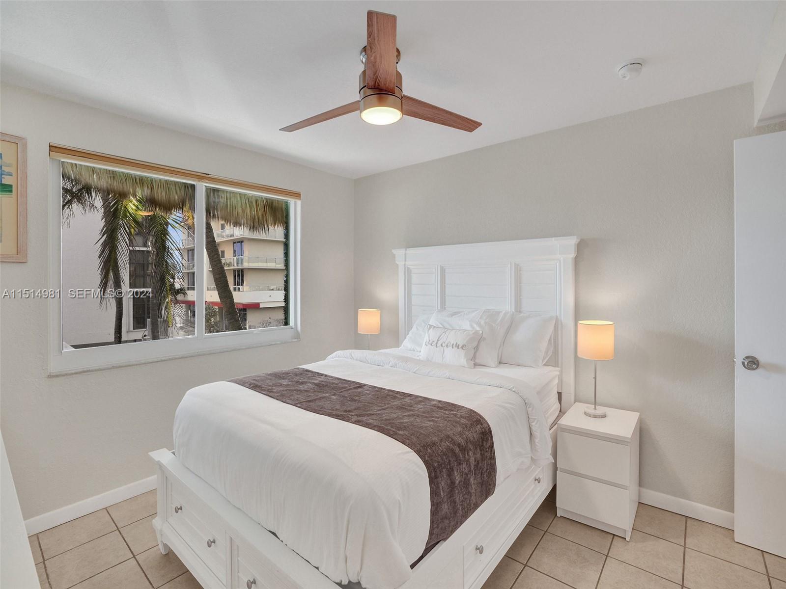 900 North Surf Road, Unit 2 Hollywood, FL 33019 - Photo 19 of 48 a bedroom with a bed and a painting on the wall