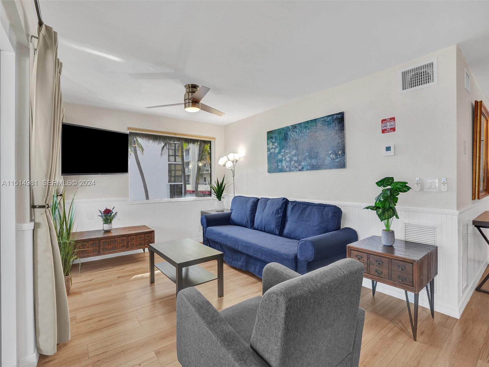 900 North Surf Road, Unit 2 Hollywood, FL 33019 - Photo 23 of 48 a living room with furniture and a flat screen tv
