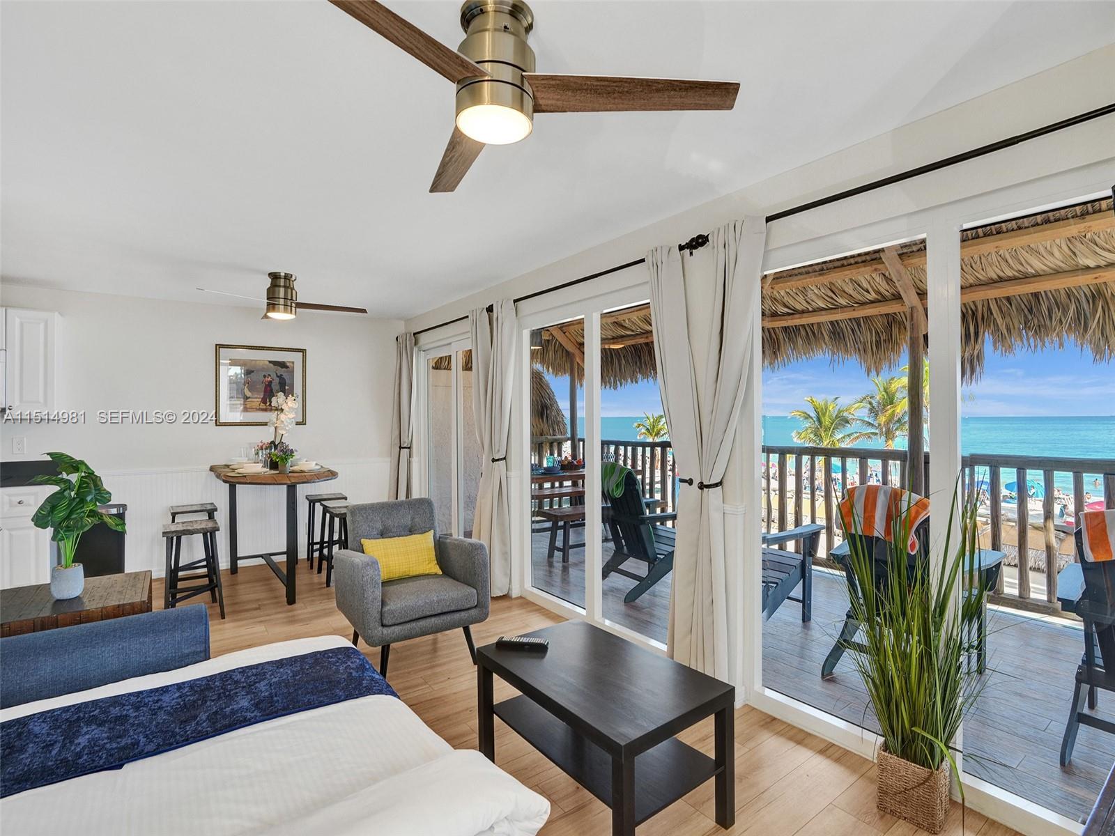 900 North Surf Road, Unit 2 Hollywood, FL 33019 - Photo 3 of 48 a living room with furniture and wooden floor