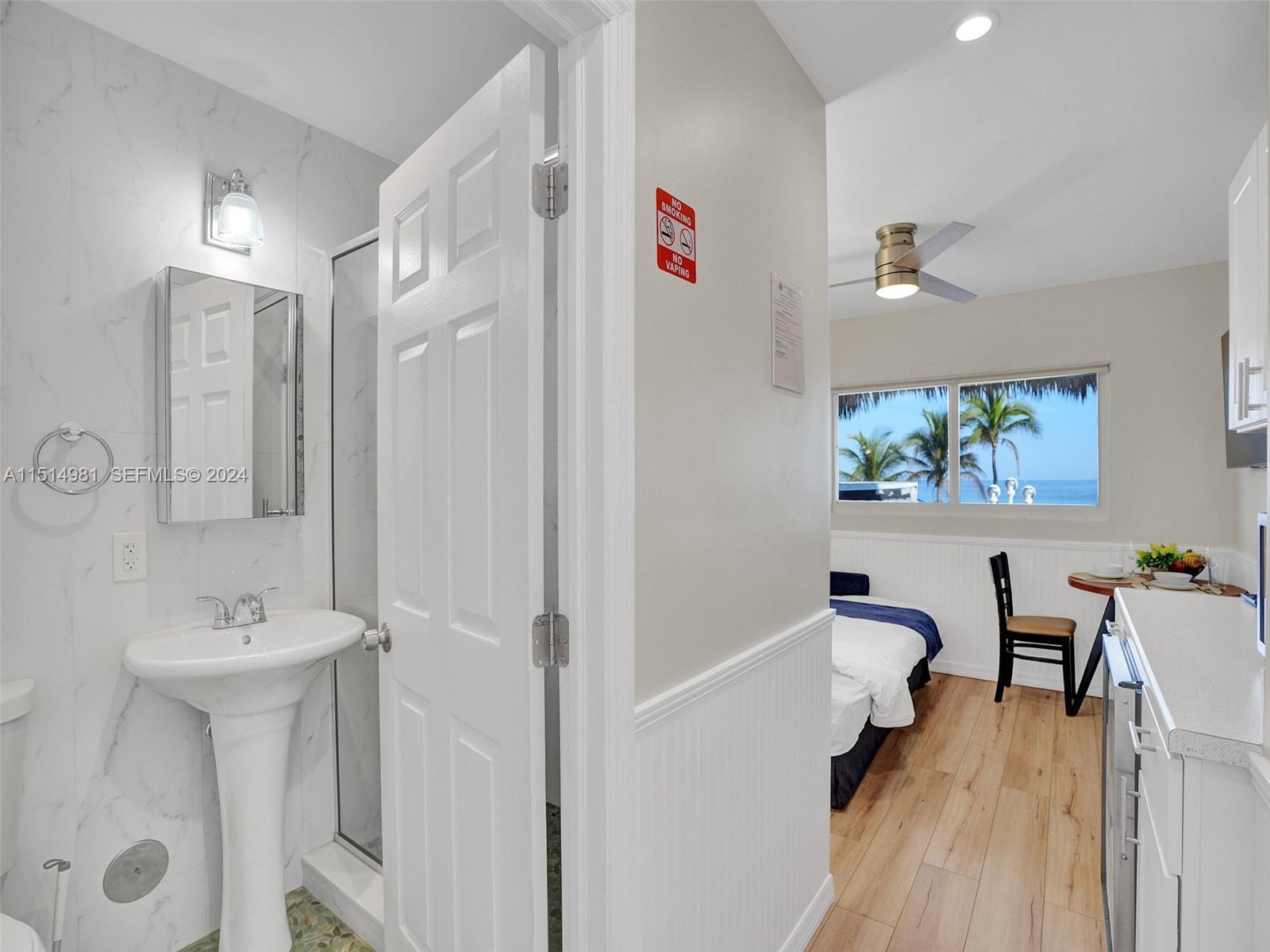 900 North Surf Road, Unit 2 Hollywood, FL 33019 - Photo 31 of 48 a bathroom with a sink mirror bathtub and toilet