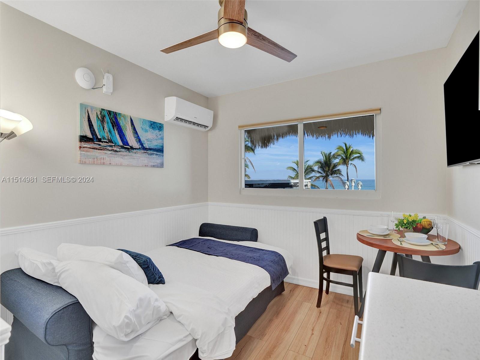 900 North Surf Road, Unit 2 Hollywood, FL 33019 - Photo 32 of 48 a bedroom with a bed and a painting on the wall