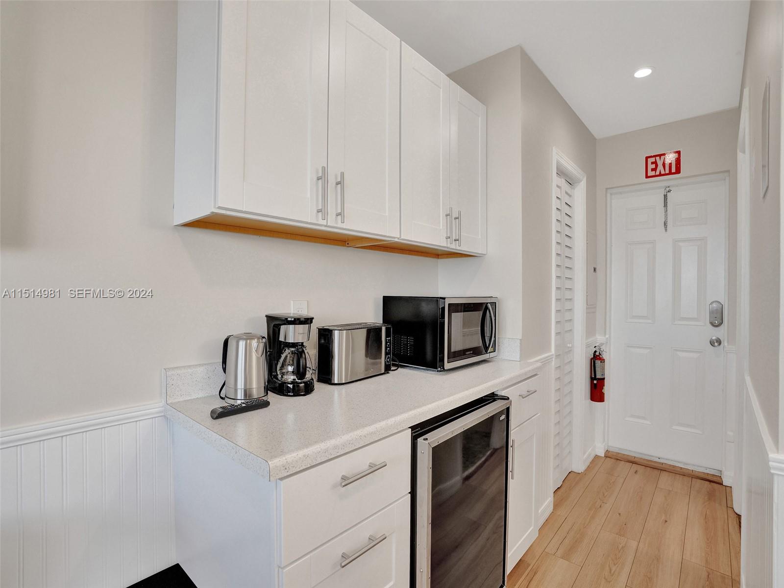 900 North Surf Road, Unit 2 Hollywood, FL 33019 - Photo 34 of 48 a kitchen with stainless steel appliances granite countertop a sink a stove and a microwave
