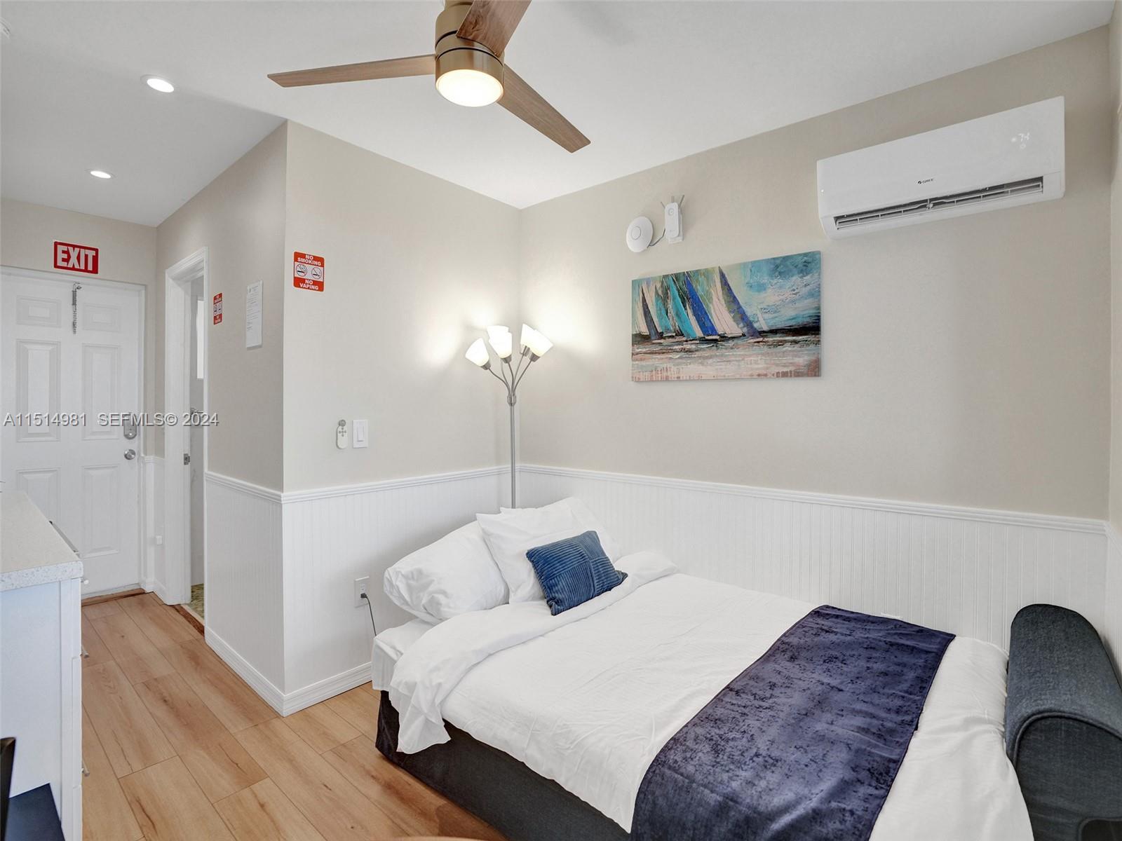900 North Surf Road, Unit 2 Hollywood, FL 33019 - Photo 36 of 48 a bedroom with a bed and a chandelier
