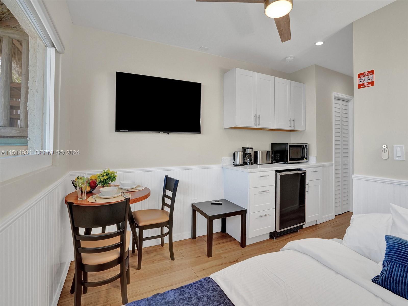 900 North Surf Road, Unit 2 Hollywood, FL 33019 - Photo 37 of 48 a living room with furniture and a flat screen tv