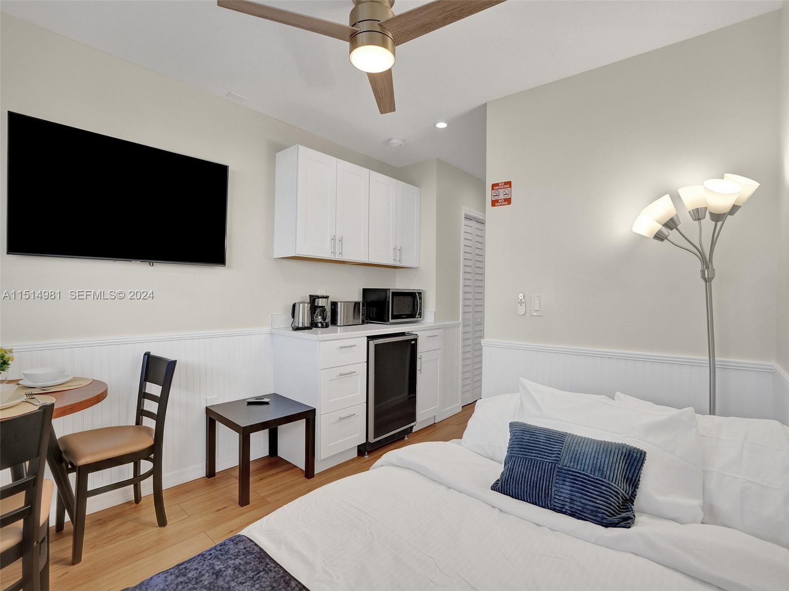 900 North Surf Road, Unit 2 Hollywood, FL 33019 - Photo 38 of 48 a living room with furniture a flat screen tv and kitchen view