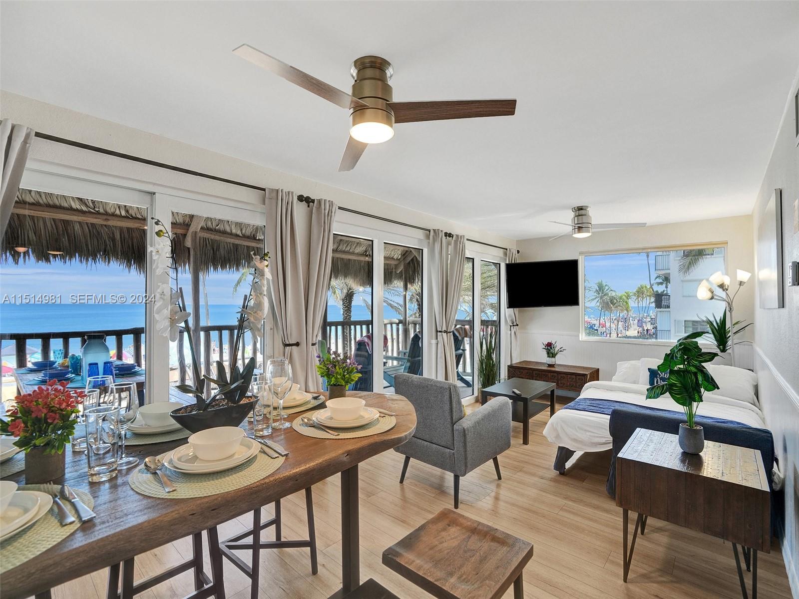 900 North Surf Road, Unit 2 Hollywood, FL 33019 - Photo 4 of 48 a living room with furniture and a flat screen tv
