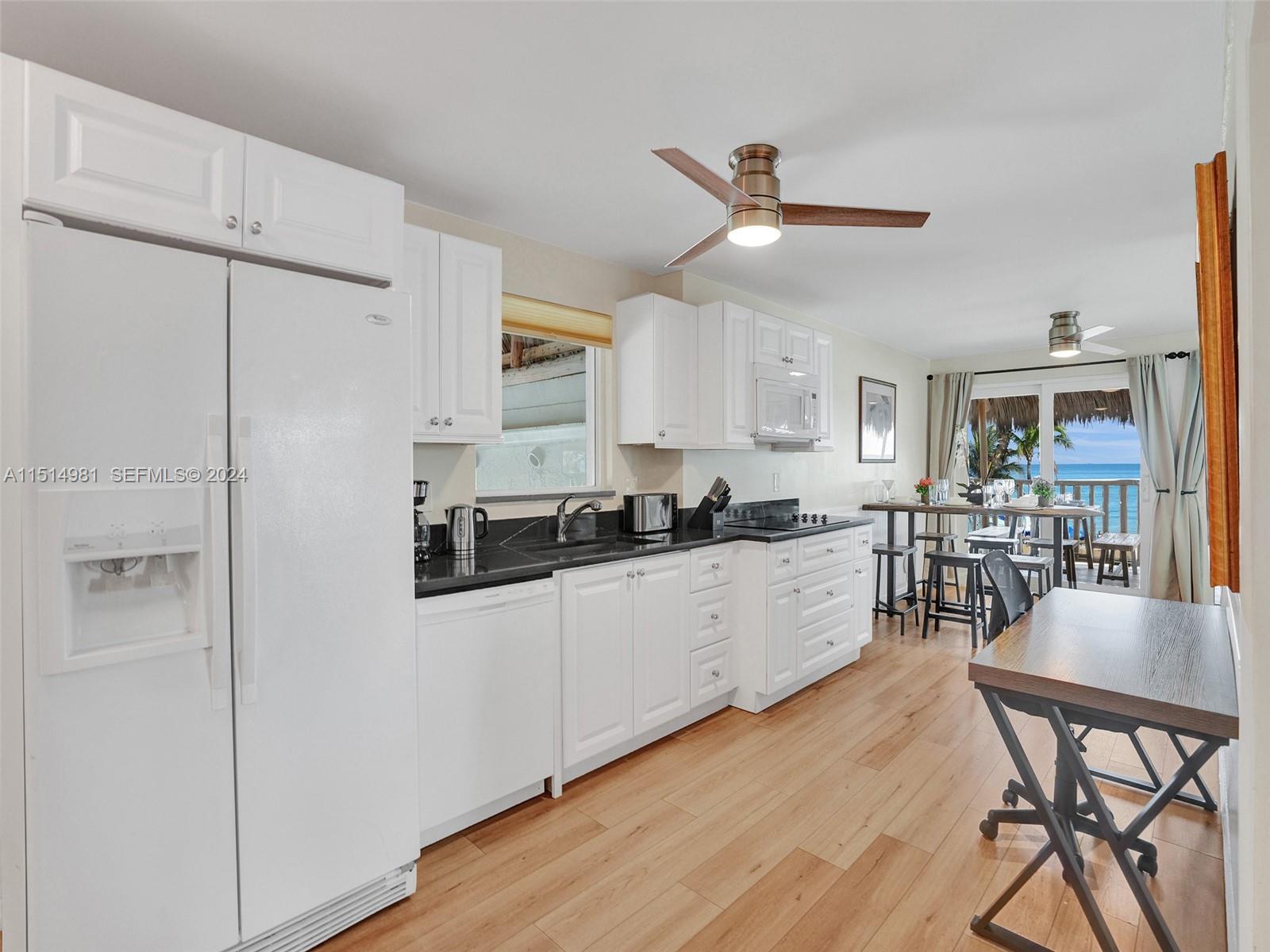 900 North Surf Road, Unit 2 Hollywood, FL 33019 - Photo 6 of 48 a living room with stainless steel appliances kitchen island granite countertop furniture and wooden floor