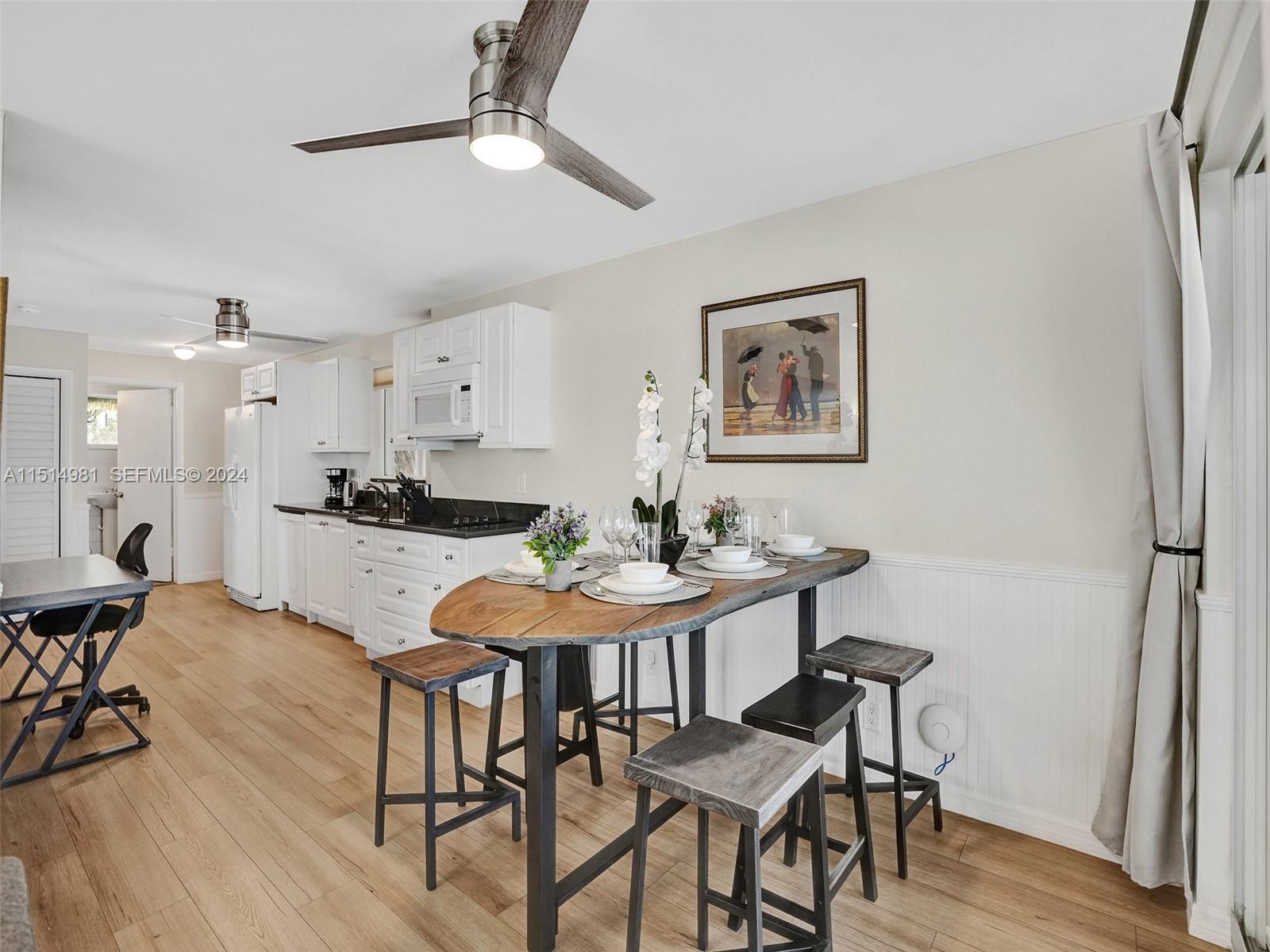 900 North Surf Road, Unit 2 Hollywood, FL 33019 - Photo 9 of 48 a view of a dining room with furniture and wooden floor