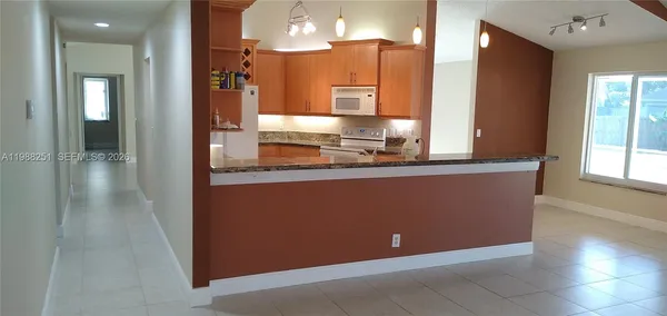 a kitchen with stainless steel appliances granite countertop a refrigerator and a sink