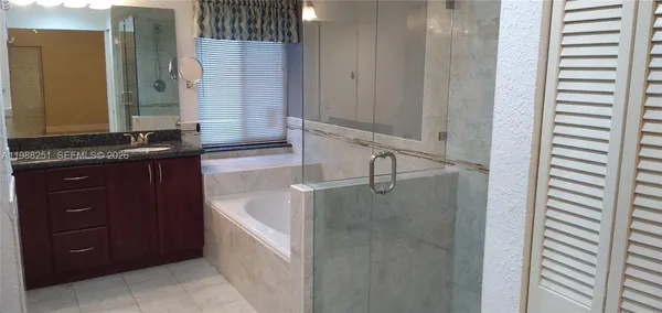 a bathroom with a granite countertop sink a vanity and a mirror