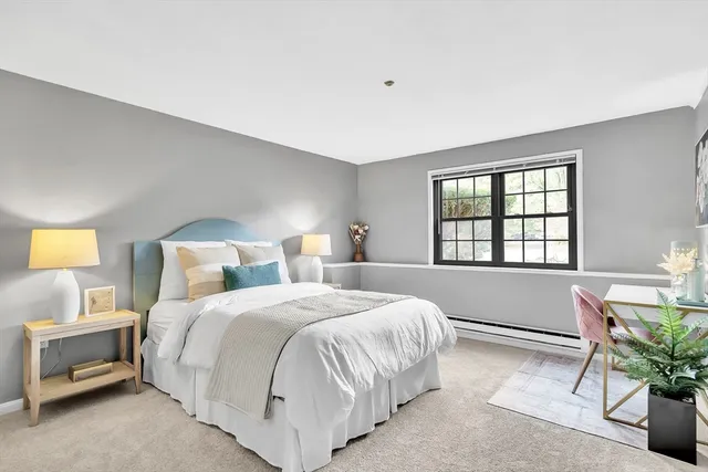 a bedroom with a bed and a potted plant