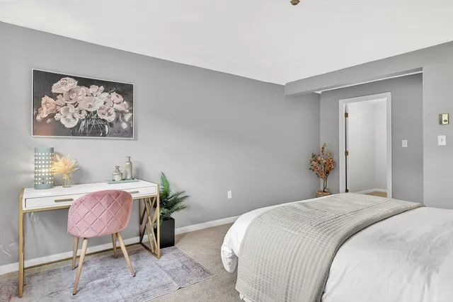 a bedroom with a bed and chair