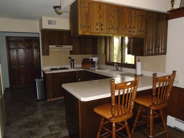 859 North 21st Road Tonica, IL 61370 - Photo 9 of 31 a kitchen with stainless steel appliances granite countertop a sink a stove a refrigerator a dining table and chairs