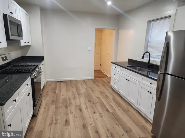 a view of a room with wooden floor