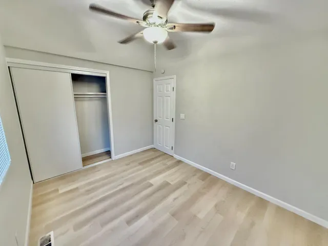 a view of a room with wooden floor
