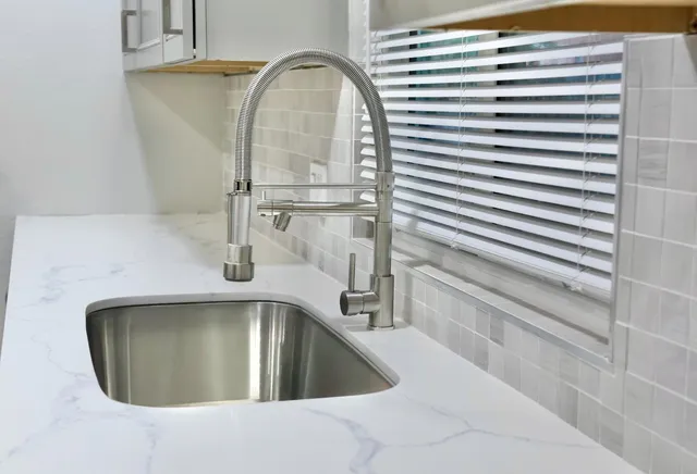 a kitchen with kitchen island a sink appliances and cabinets