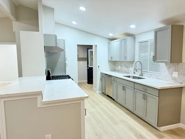 an empty room with a window and a ceiling fan