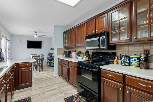 a kitchen with stainless steel appliances a stove sink microwave and cabinets