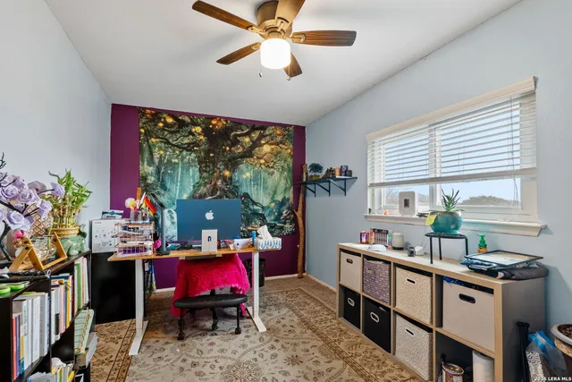 a living room with furniture a window and a flat screen tv