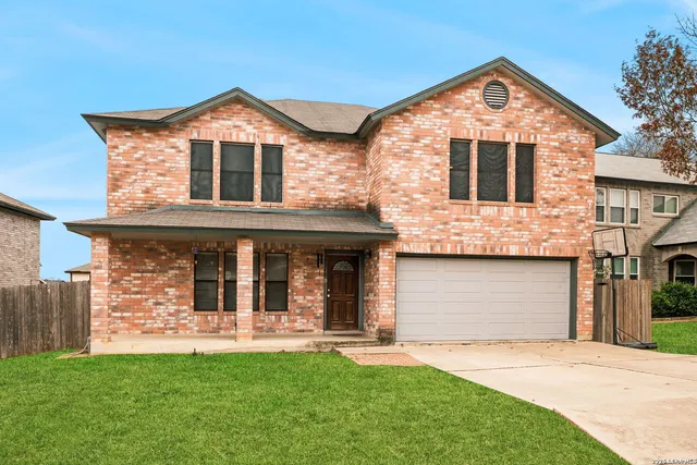a view of a white house with a small yard and a large window