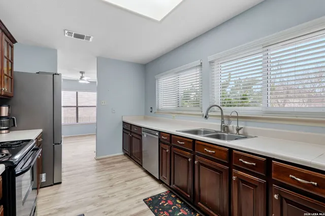 a kitchen with stainless steel appliances granite countertop a sink stove and refrigerator