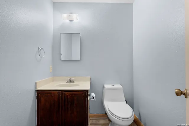 a bathroom with a toilet a sink and mirror