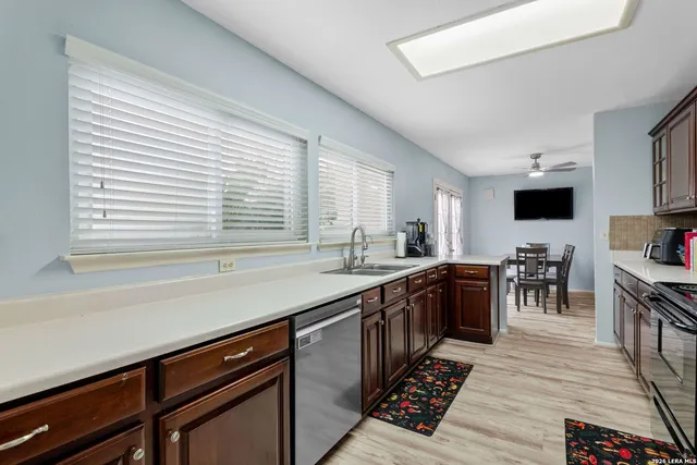 a kitchen with stainless steel appliances granite countertop a sink stove and cabinets