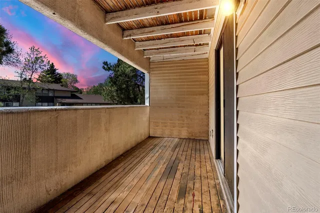 a view of balcony with wooden floor and city view