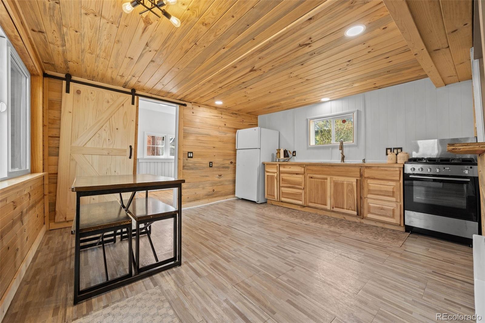 15535 South Elk Creek Road Pine, CO 80470 - Photo 12 of 25 a kitchen with stainless steel appliances a stove a sink dishwasher and a refrigerator