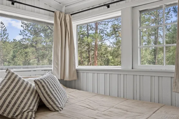 a view of room with window and a ceiling fan