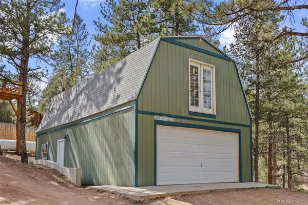 a blue house with trees in front of it