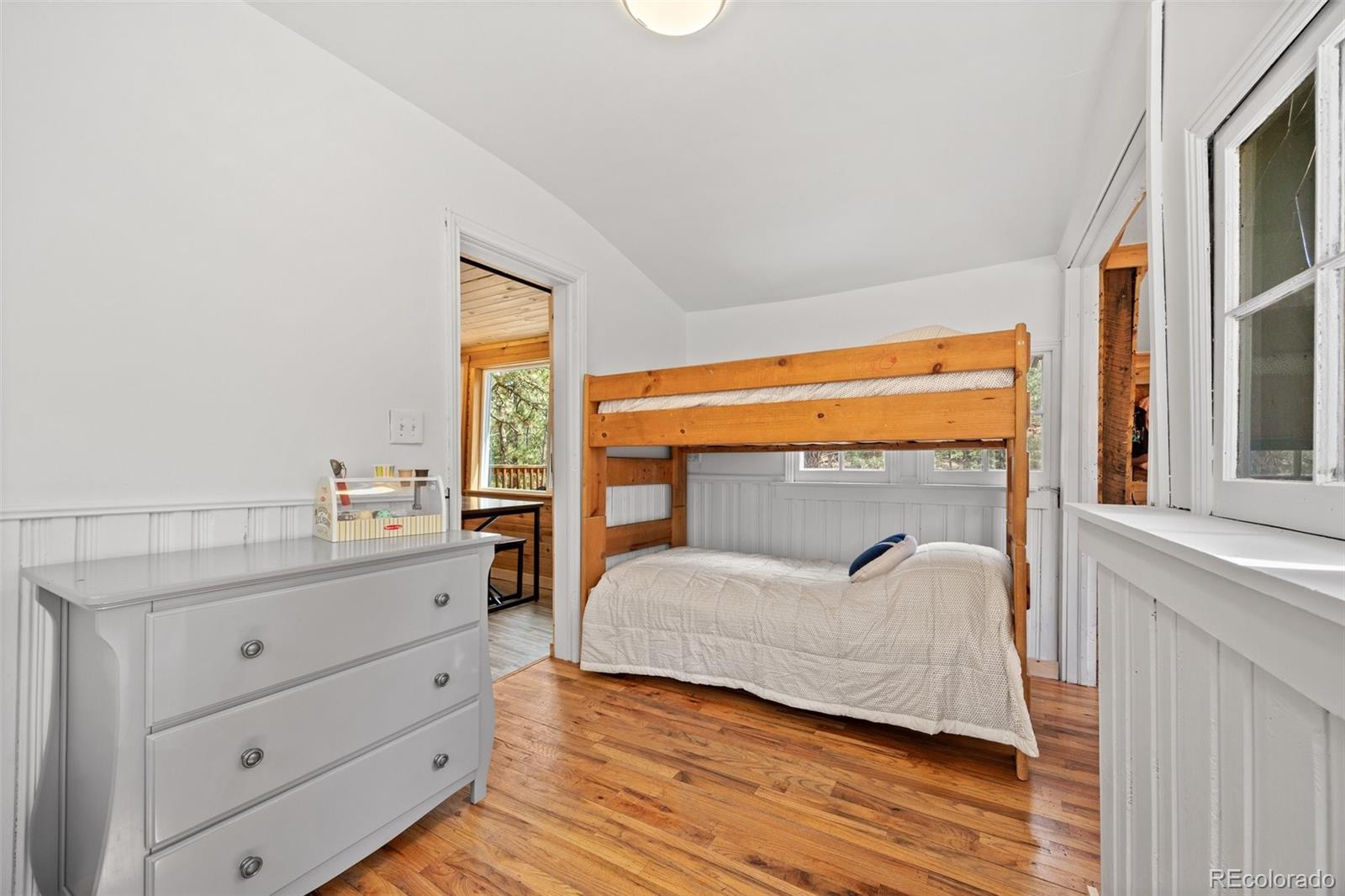 15535 South Elk Creek Road Pine, CO 80470 - Photo 22 of 25 a bedroom with a bed and a window