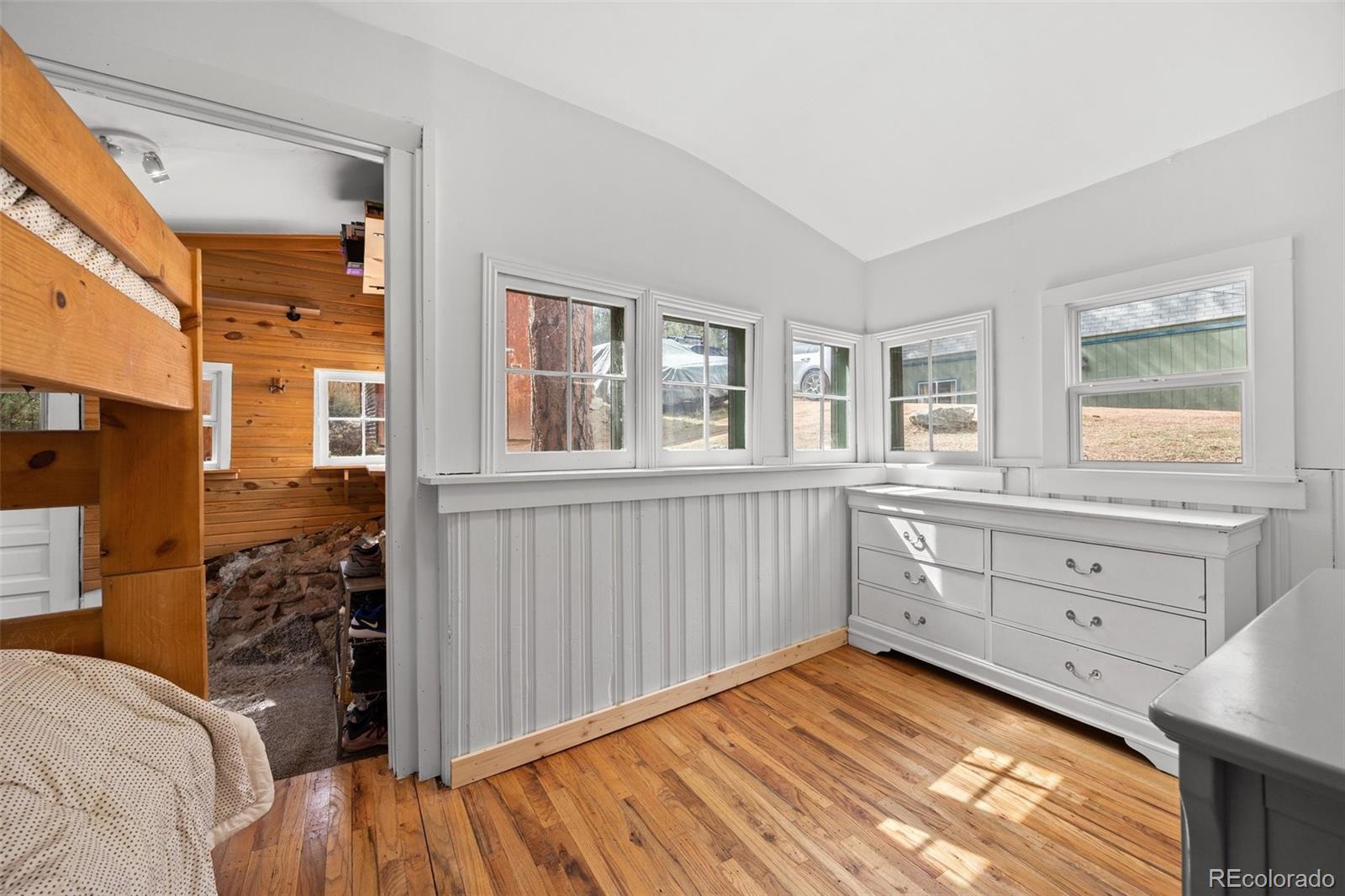 15535 South Elk Creek Road Pine, CO 80470 - Photo 23 of 25 a bedroom with a bed and a window