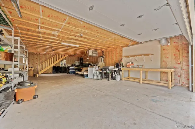 a front view of a house with yard and trees around